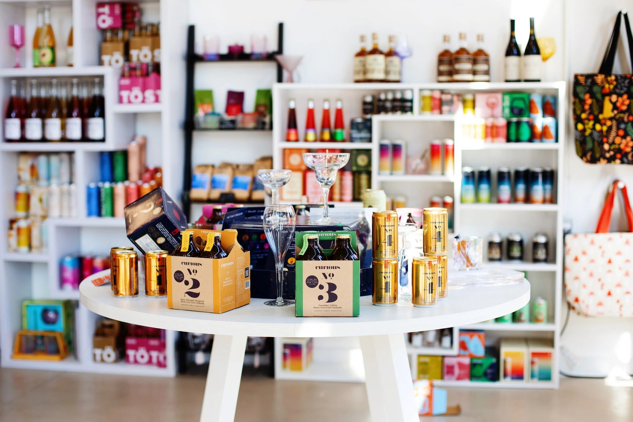 Beyond Bottleshop interior with shelves of colorful non-alcoholic bottles and cans and a central display table