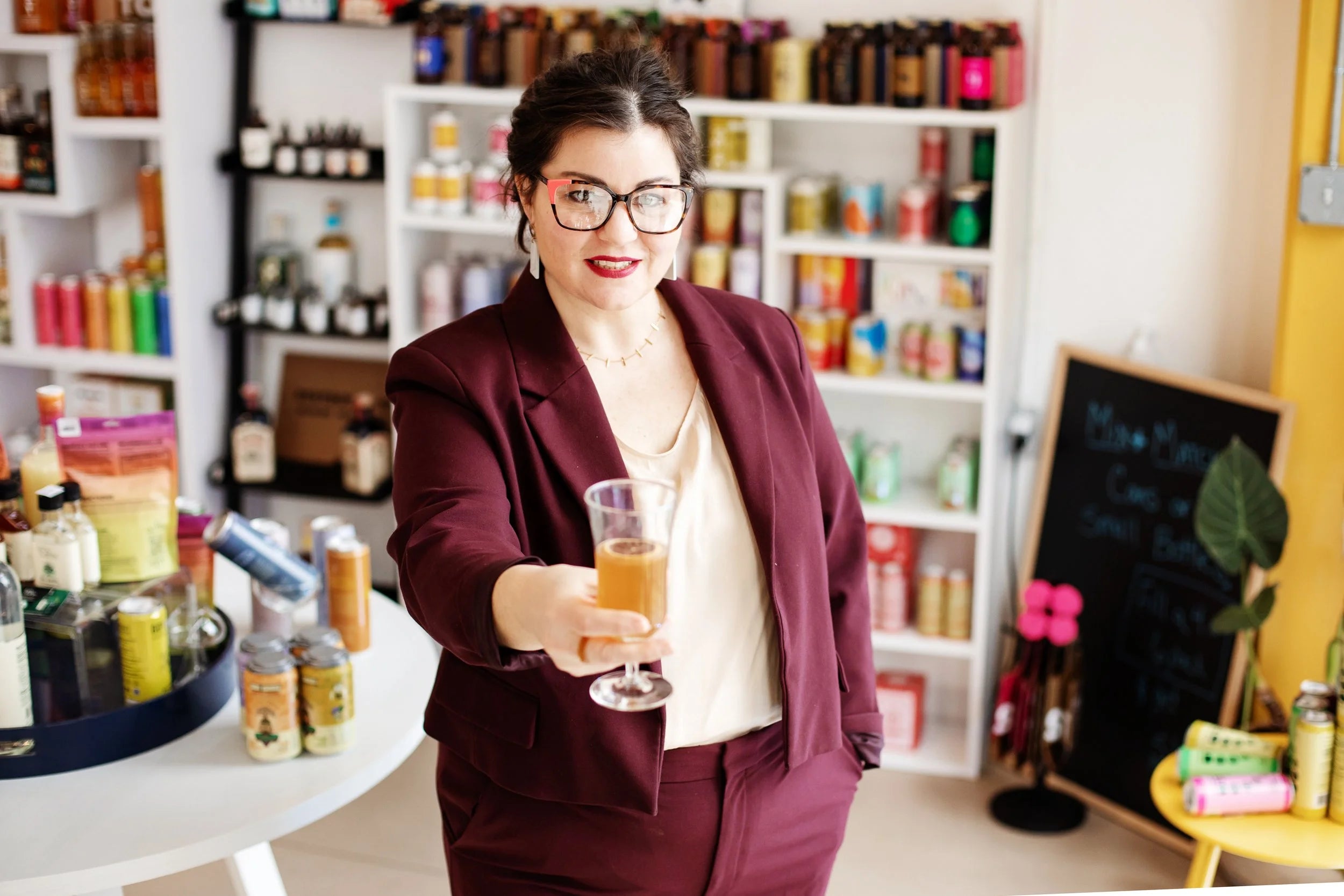 Beyond Bottleshop owner offering a freshly made non-alcoholic cocktail inside the shop